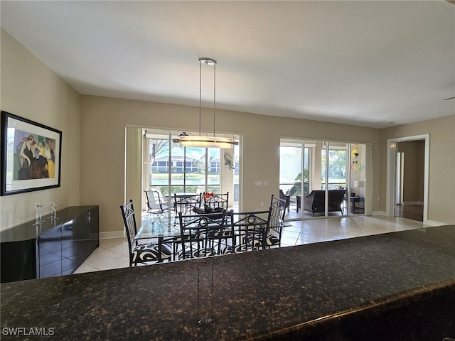 unfurnished dining area with light tile patterned floors and a healthy amount of sunlight