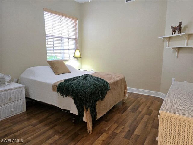 bedroom featuring dark hardwood / wood-style flooring