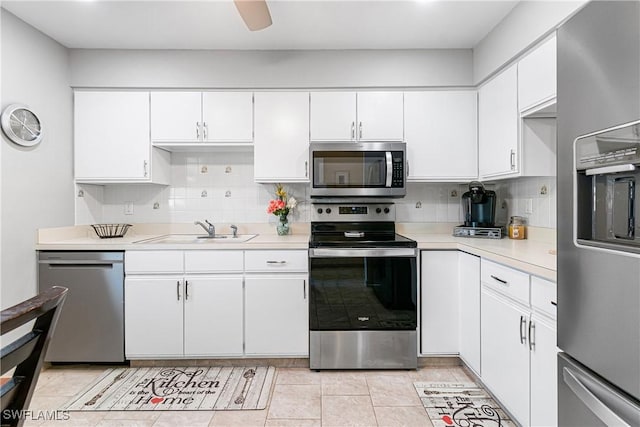 kitchen with stainless steel appliances, white cabinetry, and sink