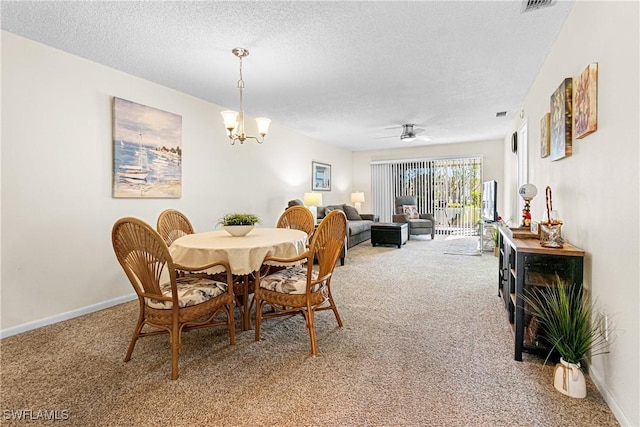 carpeted dining area featuring ceiling fan with notable chandelier and a textured ceiling