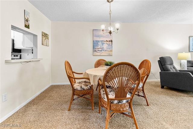 dining space featuring carpet flooring, a notable chandelier, and a textured ceiling