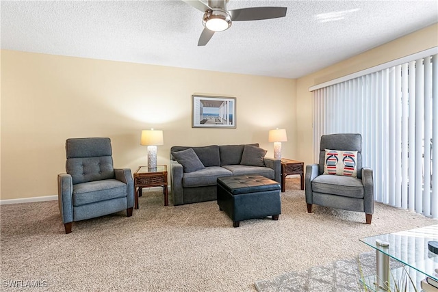 living room with a textured ceiling, carpet floors, and ceiling fan