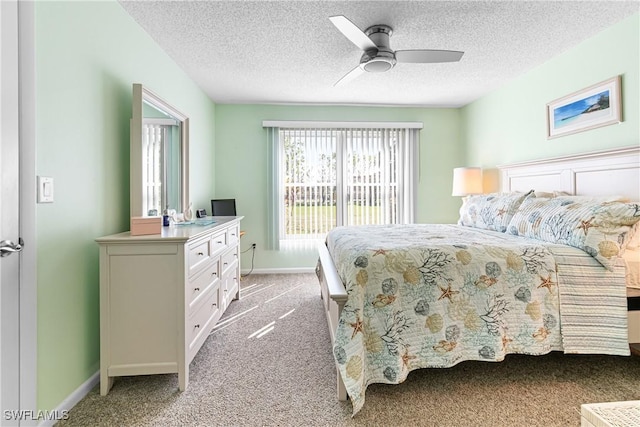 carpeted bedroom with ceiling fan and a textured ceiling