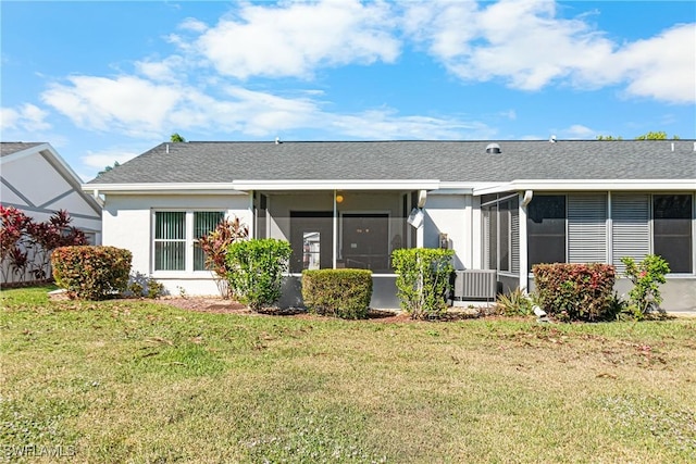 back of property featuring a lawn and central AC