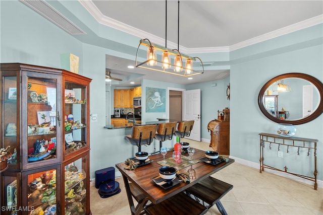 tiled dining space with ornamental molding and sink