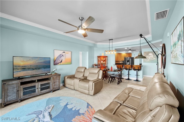 tiled living room with ceiling fan and ornamental molding