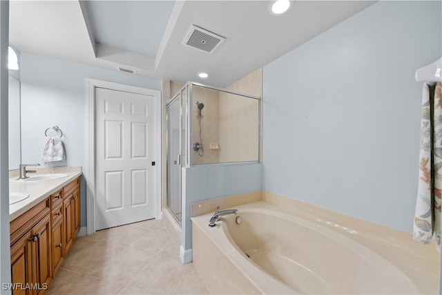 bathroom with tile patterned flooring, vanity, and shower with separate bathtub