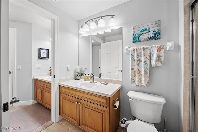 bathroom with tile patterned flooring, vanity, and toilet