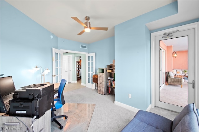 home office with french doors, light colored carpet, and ceiling fan