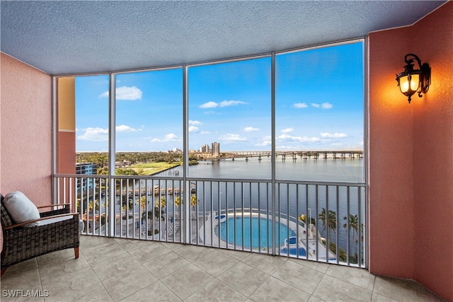 sunroom / solarium with a water view