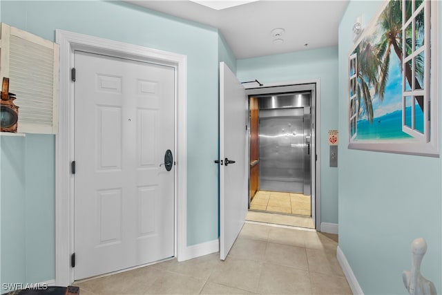 hallway featuring light tile patterned floors