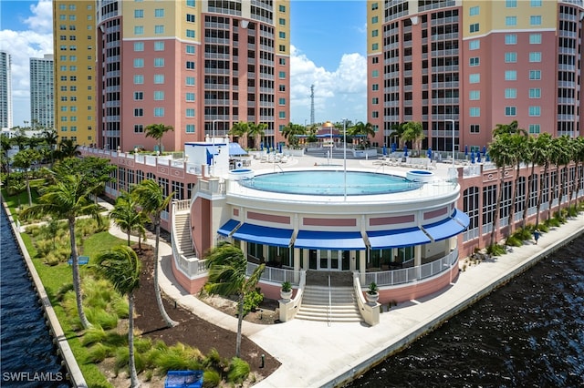 exterior space with a water view and a jacuzzi