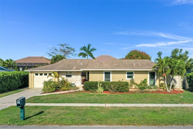 ranch-style home featuring a front lawn and a garage