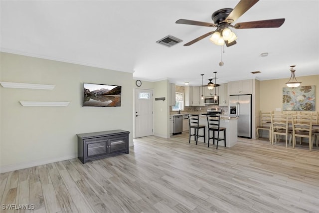 unfurnished living room featuring a ceiling fan, light wood-style floors, visible vents, and baseboards