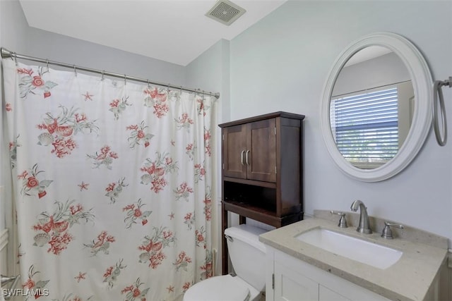 bathroom with visible vents, curtained shower, toilet, and vanity