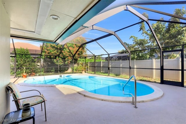 view of pool featuring a fenced in pool, a patio, glass enclosure, and fence