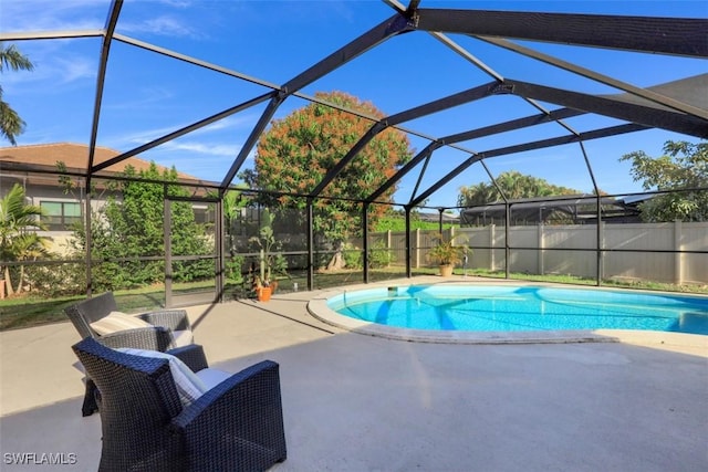 view of swimming pool featuring a patio area, a fenced in pool, a lanai, and fence