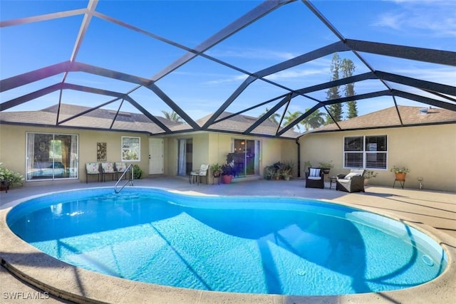 outdoor pool with glass enclosure, outdoor lounge area, and a patio