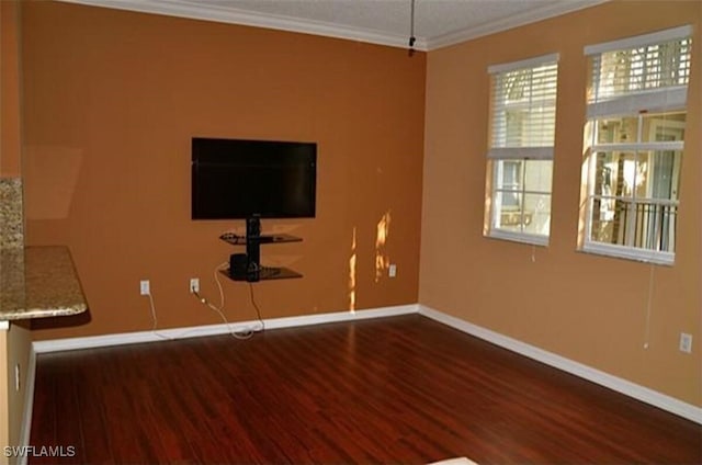 empty room featuring dark hardwood / wood-style floors and ornamental molding