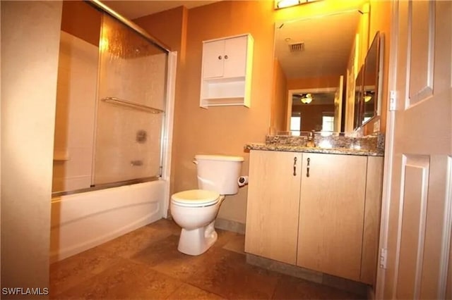 full bathroom featuring vanity, toilet, and enclosed tub / shower combo