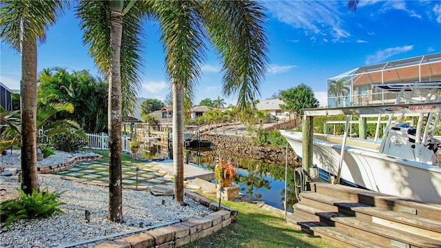 dock area with a water view and a lanai