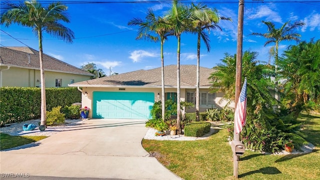 view of front of house featuring a garage and a front lawn