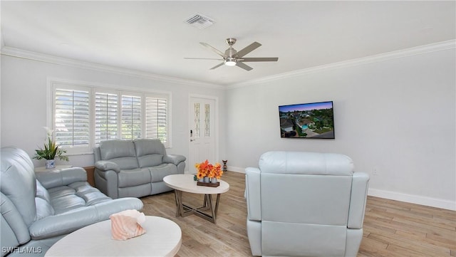 living room with light hardwood / wood-style floors, ceiling fan, and crown molding