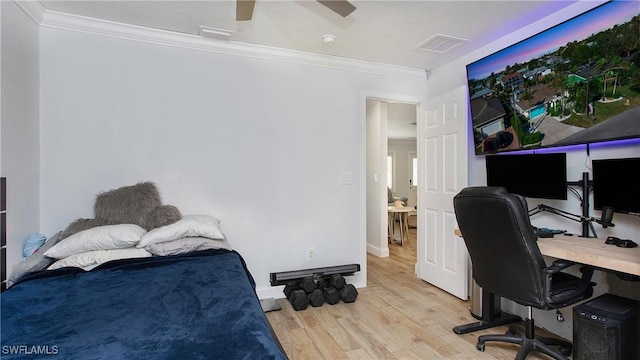 bedroom with light wood-type flooring, ceiling fan, and ornamental molding