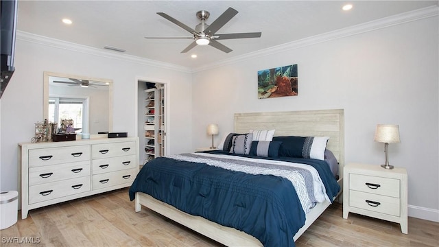 bedroom with ceiling fan, light hardwood / wood-style floors, and crown molding