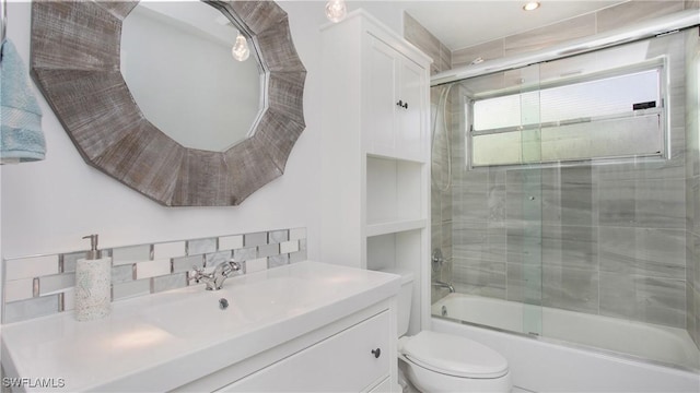 full bathroom with vanity, toilet, and enclosed tub / shower combo