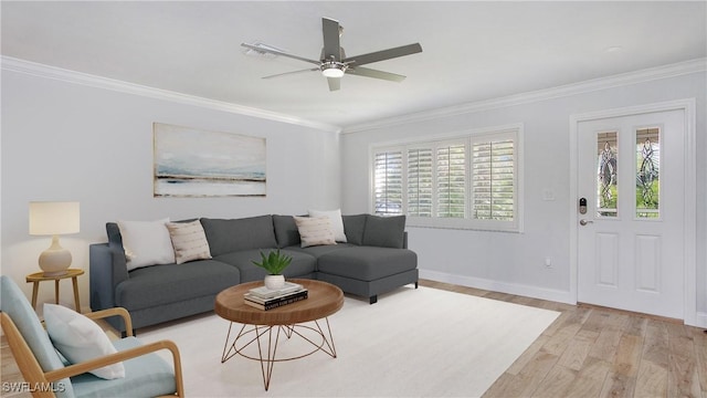 living room with light hardwood / wood-style flooring, ceiling fan, and crown molding