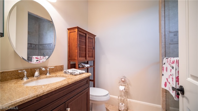 bathroom featuring tile patterned floors, vanity, and toilet