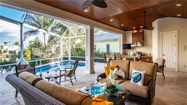 view of patio / terrace with a lanai, outdoor lounge area, and ceiling fan