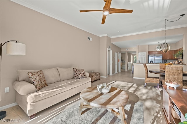 living room featuring ceiling fan with notable chandelier, light tile patterned floors, and crown molding