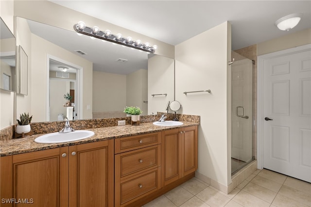 bathroom featuring tile patterned floors, vanity, and an enclosed shower