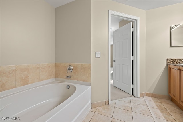 bathroom with tile patterned floors, vanity, and a bathtub