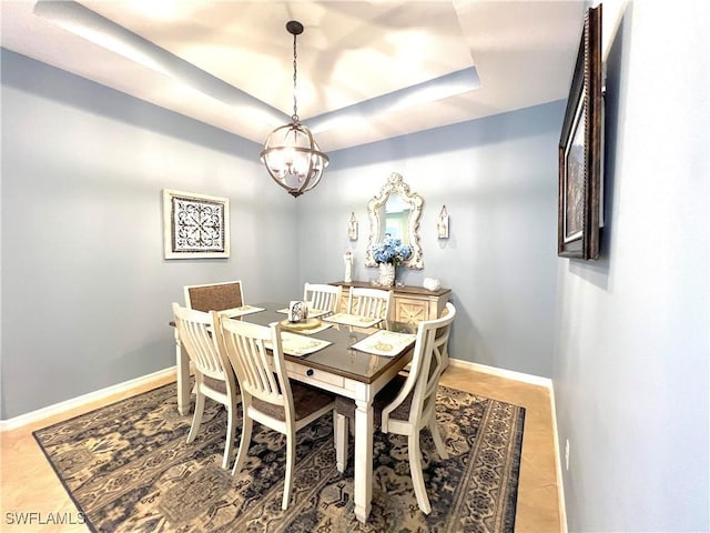 dining area with a raised ceiling