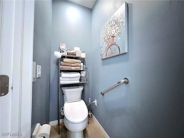 bathroom with tile patterned flooring and toilet