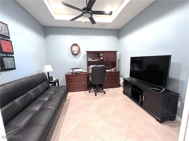 office featuring ceiling fan and a raised ceiling