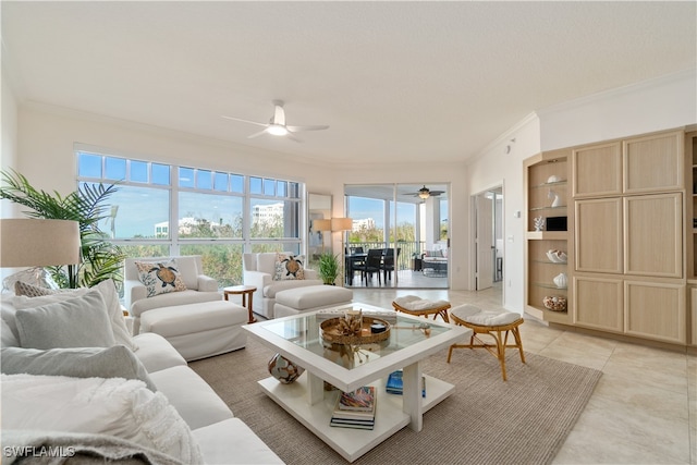 living room featuring ceiling fan, a healthy amount of sunlight, light tile patterned flooring, and ornamental molding