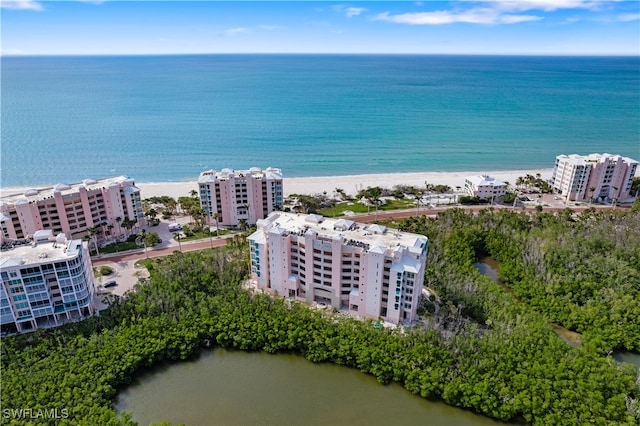 birds eye view of property with a water view and a view of the beach