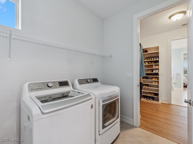 laundry area featuring light hardwood / wood-style floors and washing machine and dryer