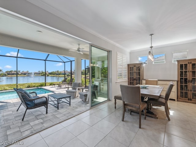 dining area with light tile patterned floors, a water view, ceiling fan, and crown molding