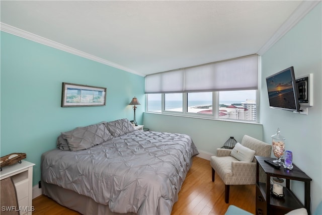 bedroom featuring light hardwood / wood-style flooring and ornamental molding