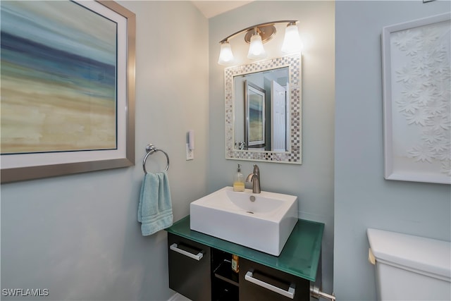 bathroom featuring vanity and toilet