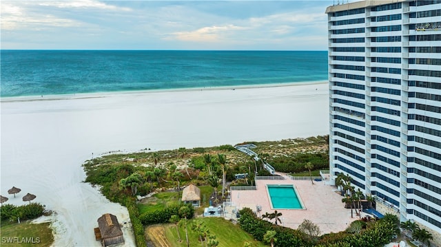 birds eye view of property with a view of the beach and a water view