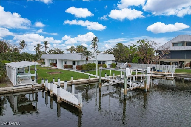 dock area with a lawn and a water view