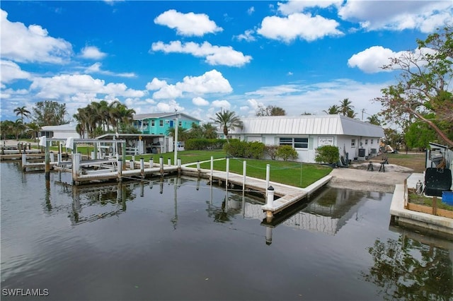 dock area featuring a water view and a lawn