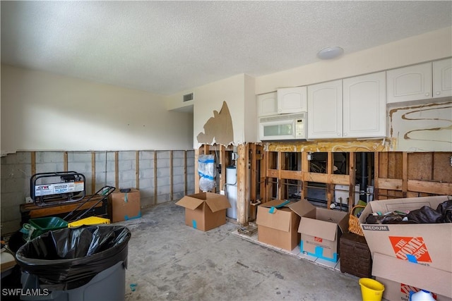 interior space with a textured ceiling