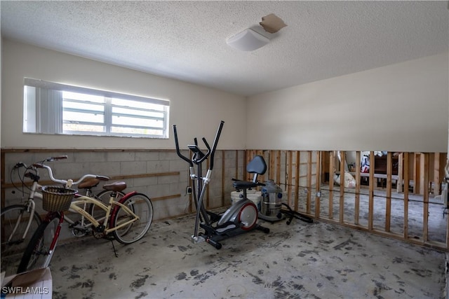 workout room with a textured ceiling